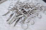 Numerous surgical scissors lying on a cloth